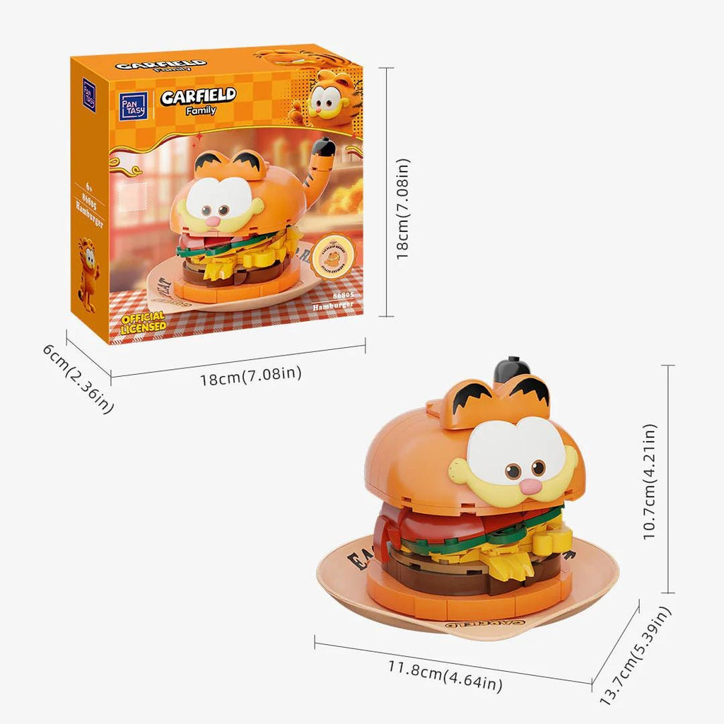 a toy resembling a cartoon character, specifically a Garfield-themed toy. The toy is a small, orange-colored figurine of a cartoon character with a large head and a smaller body. The toy is placed on a wooden base, and there are measurements provided for its size.