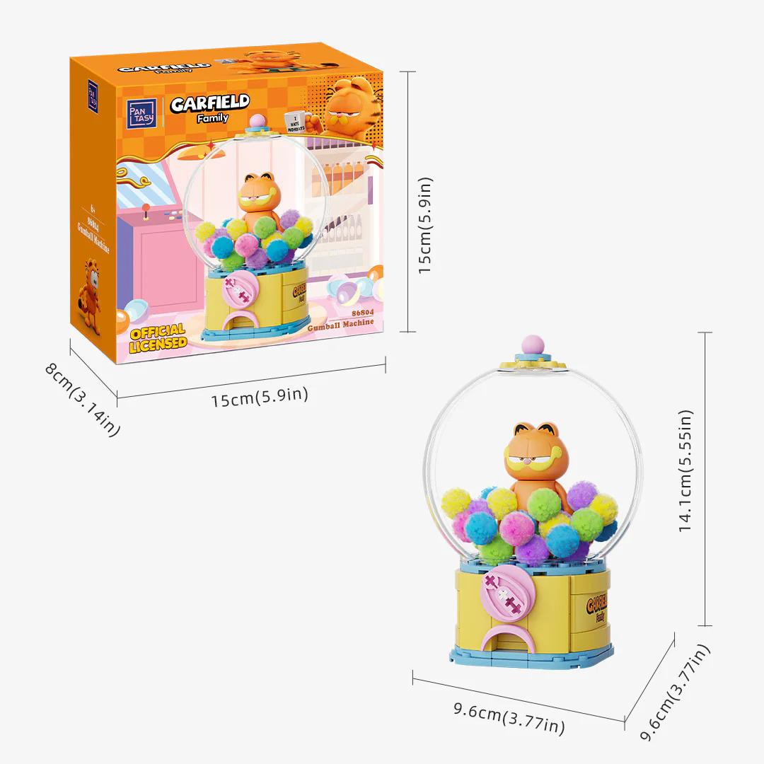 a toy called the "Garfield Family" that is a colorful, round gumball machine. The toy is shown in two different sizes: a full-sized version and a smaller, miniature version. The full-sized version is 15 cm (5 inches) tall, while the miniature version is 9.6 cm (3.7 inches) tall. The toy is packaged in a box that is also orange and white in color.