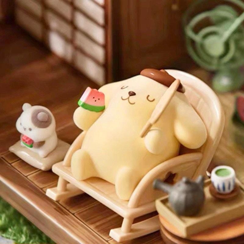 A yellow plush toy, resembling a dog, is sitting in a rocking chair and holding a watermelon slice. The toy is accompanied by a small white animal figurine and a teapot, creating a whimsical scene.
