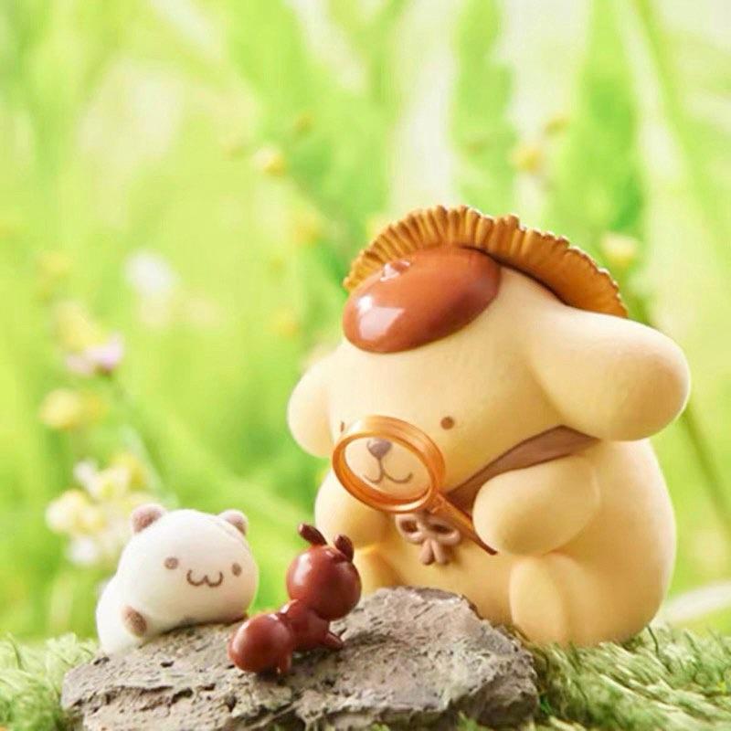 A small toy figurine of a dog wearing a hat and holding a magnifying glass, interacting with a small white toy ant on a rock.