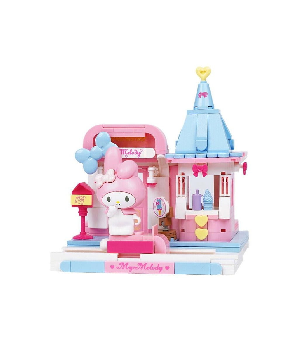 A pink and blue Hello Kitty dollhouse with a small pink dollhouse and a blue tower.