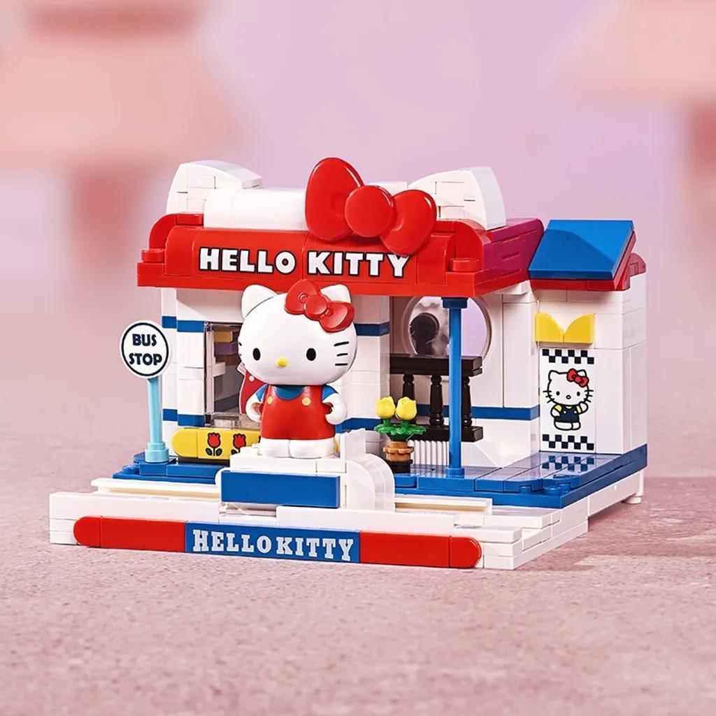 A Hello Kitty toy bus stop with a Hello Kitty figurine on top.