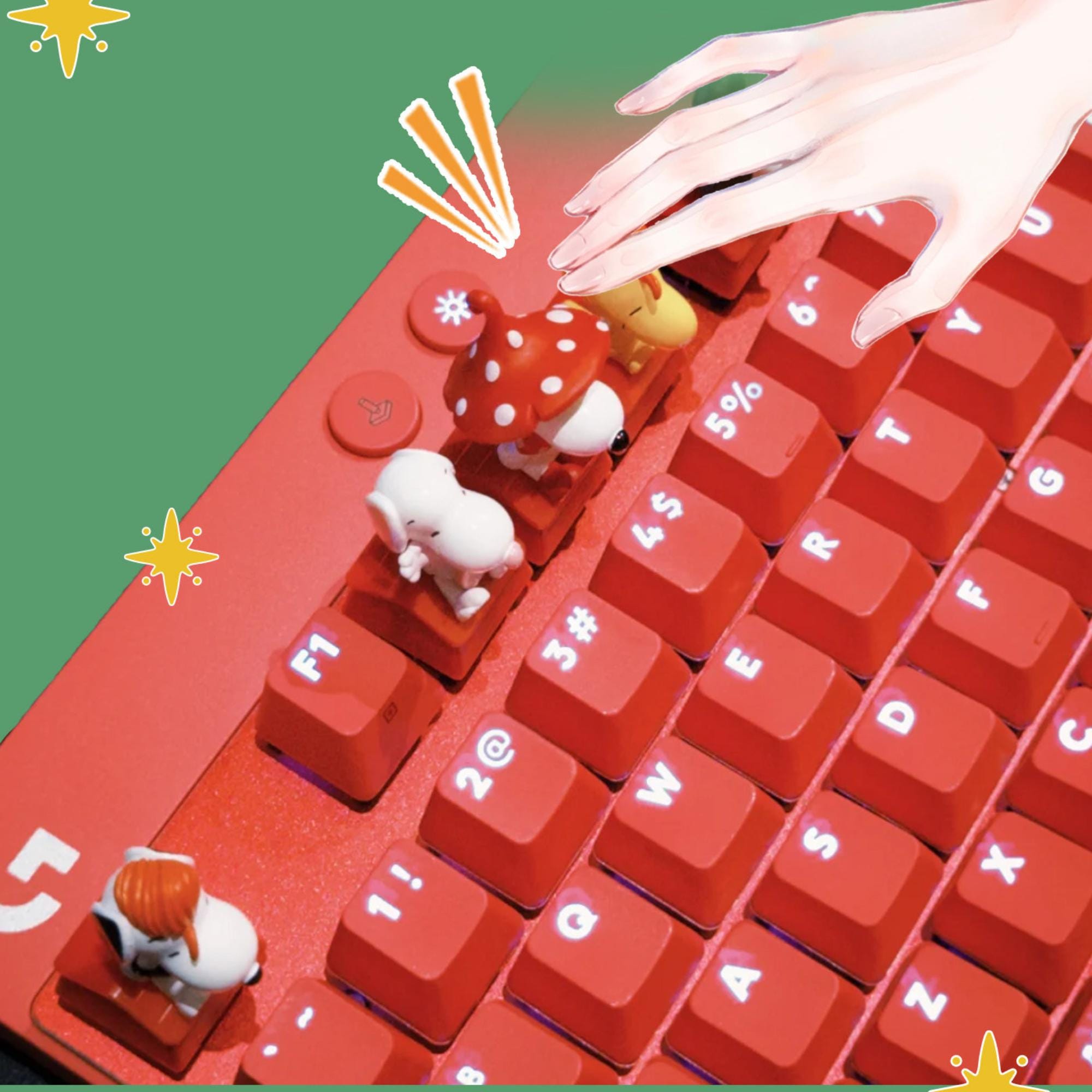 a close-up view of a red computer keyboard with various small animal figurines, including a dog, cat, and bird, placed on the keys.