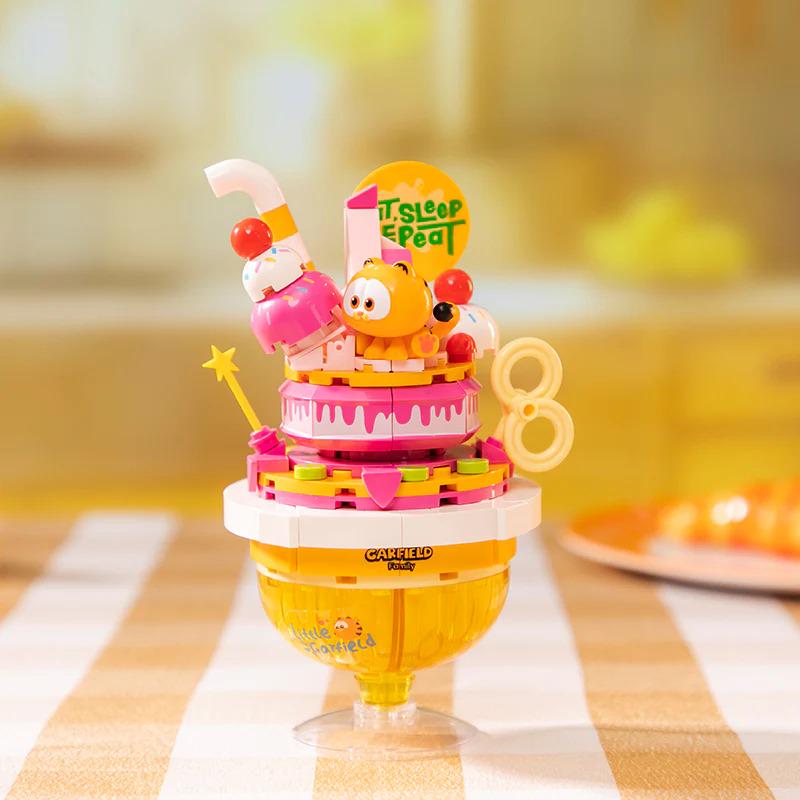 A colorful toy figurine of a dog sitting on top of a cake-shaped container, with a sign that says "It's Sleep Time" and the number "8" on it.
