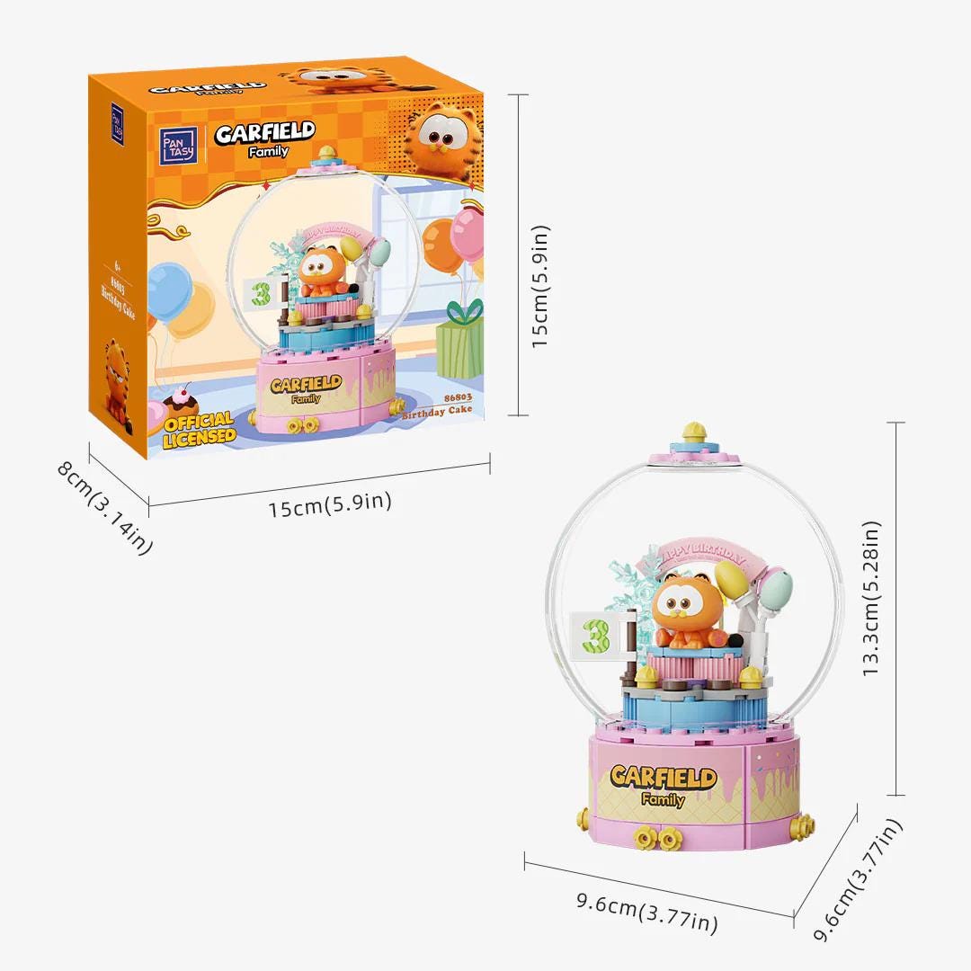 a pink and yellow toy called the "CARFIELD Family" with a clear glass dome, which appears to be a musical instrument or a decorative item. The toy is accompanied by its packaging, which includes dimensions and a description of the toy's features.