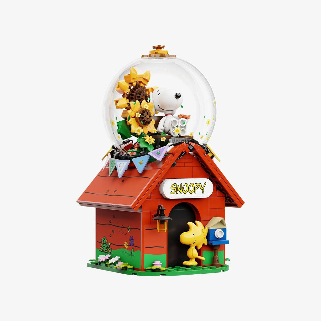 A Lego model of a red house with a clear dome containing a cartoon character, likely a character from the Peanuts comic strip.