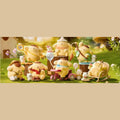 A collection of small, colorful figurines of cartoon-like animals, including dogs, cats, and other small creatures, arranged on a grassy surface.