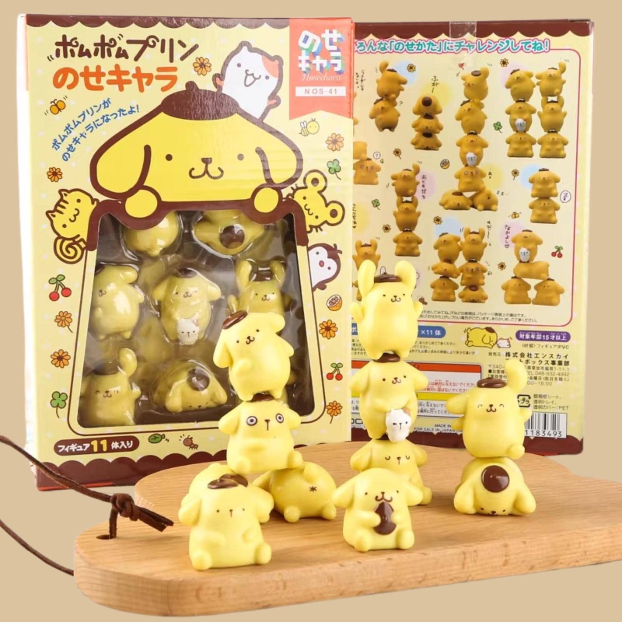 a collection of yellow, cartoon-like figurines, likely representing various animals or characters, displayed on a wooden surface.