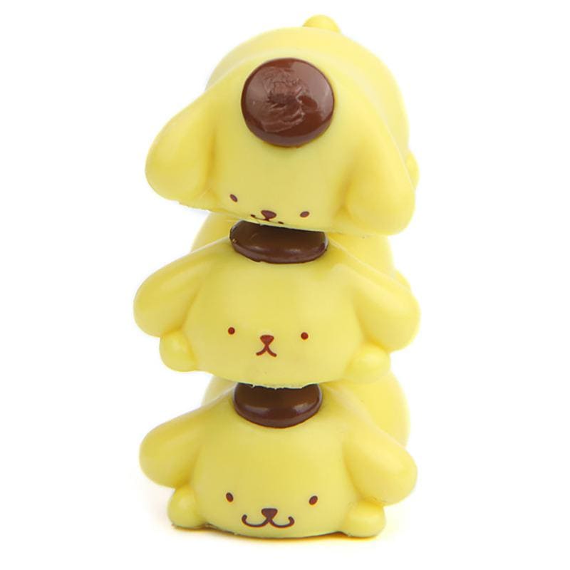 A stack of three yellow rubber duckies with brown spots on their heads.