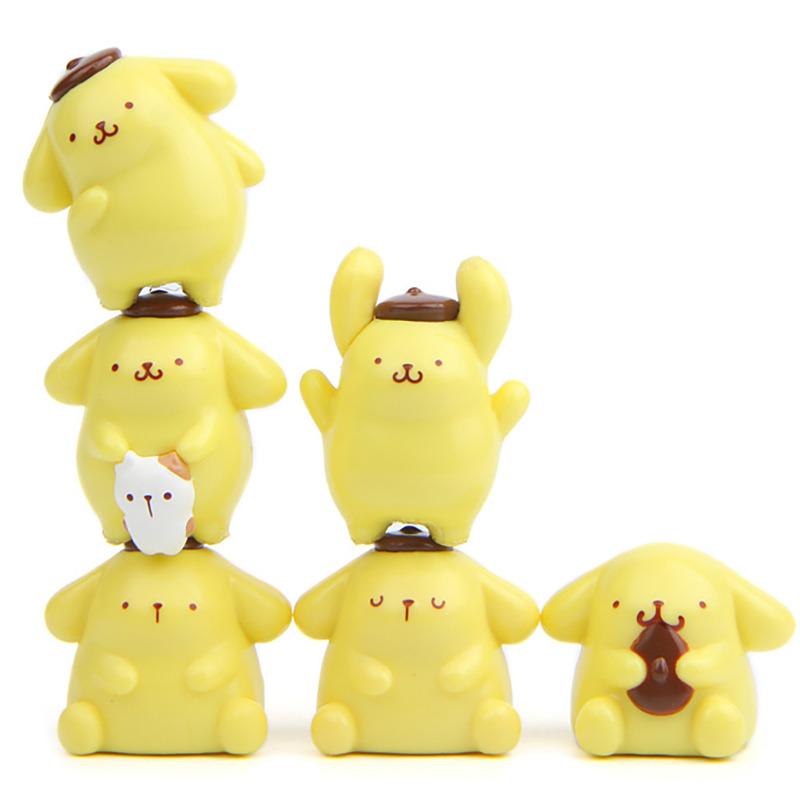 A group of yellow, cartoon-like figurines or toys arranged in a row.