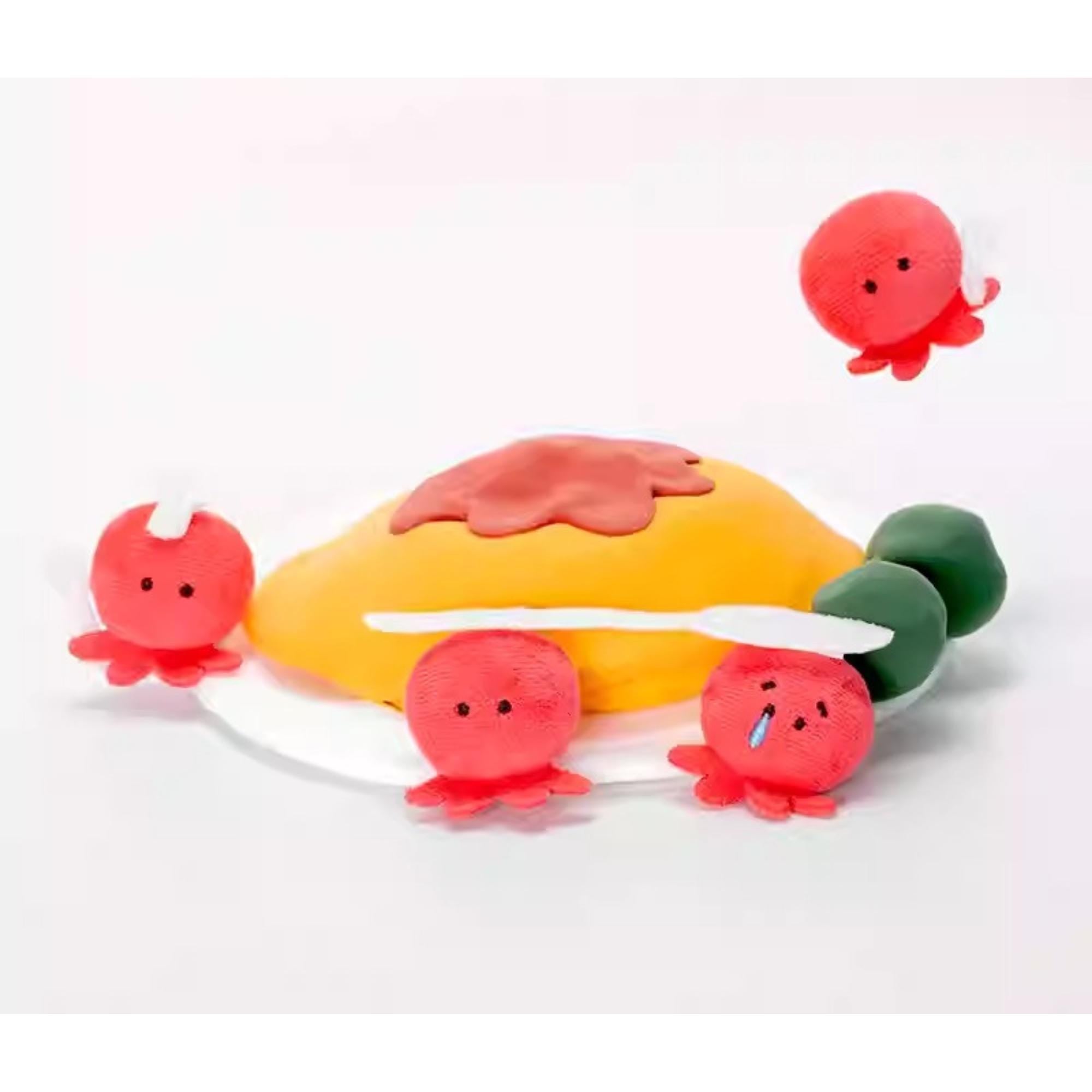 A group of red octopus-shaped plush toys are sitting on a yellow surface, with one octopus holding a spoon.