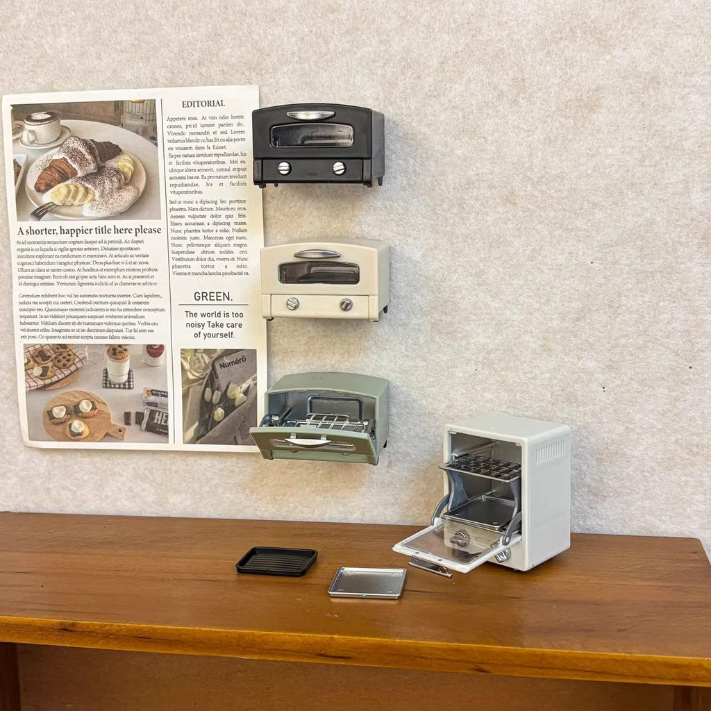 a wooden table with four miniature toaster ovens displayed on it, along with a newspaper article and a small green plant.