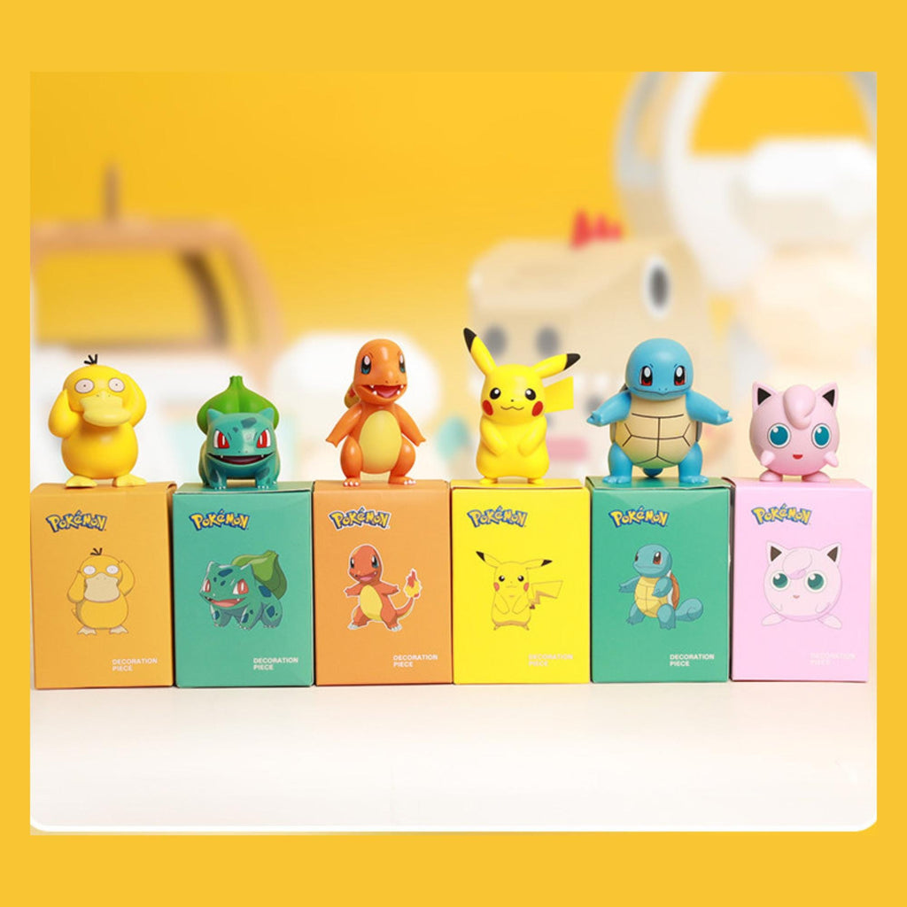 A collection of Pokemon figurines and their corresponding boxes, arranged in a row on a surface.