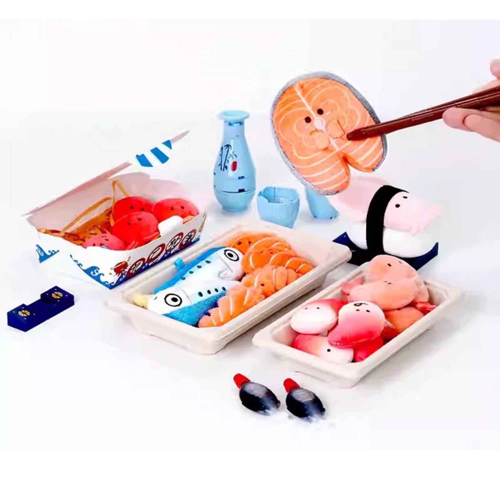 a variety of food items, including sushi, and a hand holding chopsticks. There are also some small toy figures and other miscellaneous items scattered around the scene.