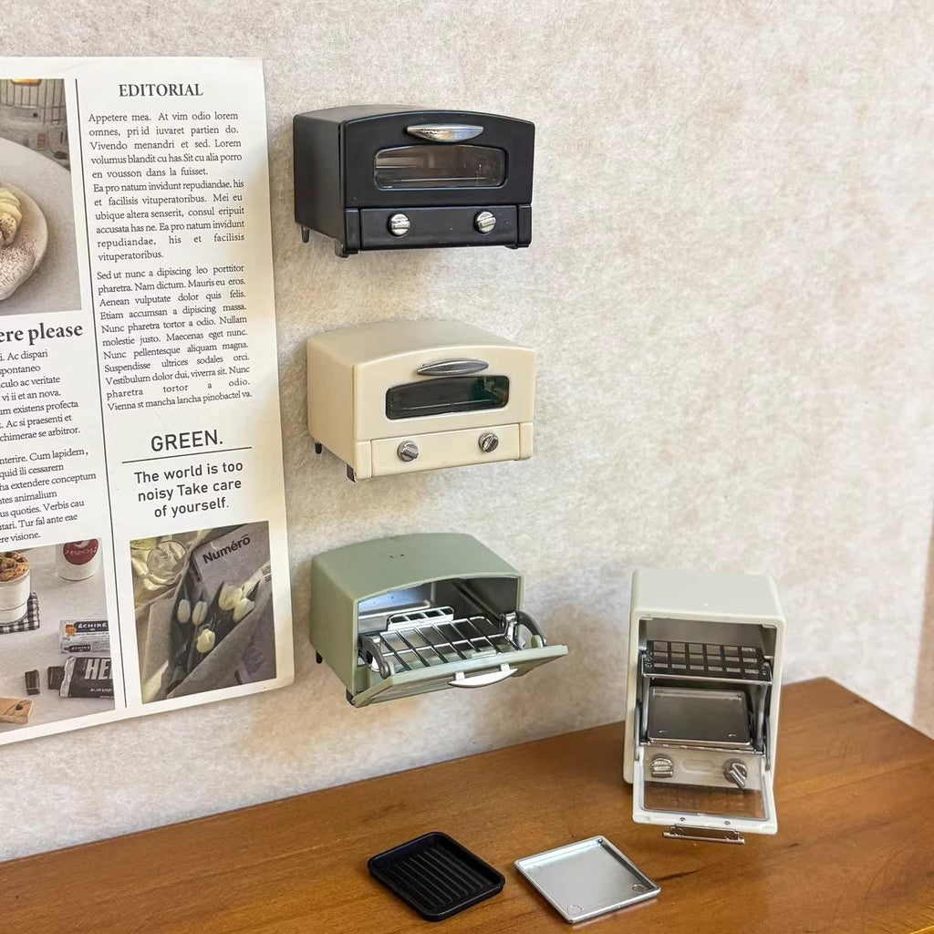 a collection of miniature toaster ovens displayed on a wooden surface, with a newspaper article visible in the background.
