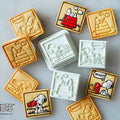 various shaped cookies decorated with images of the popular cartoon character Snoopy.