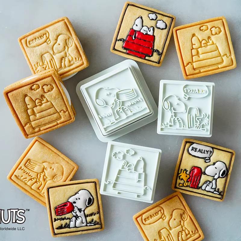 various shaped cookies decorated with images of the popular cartoon character Snoopy.