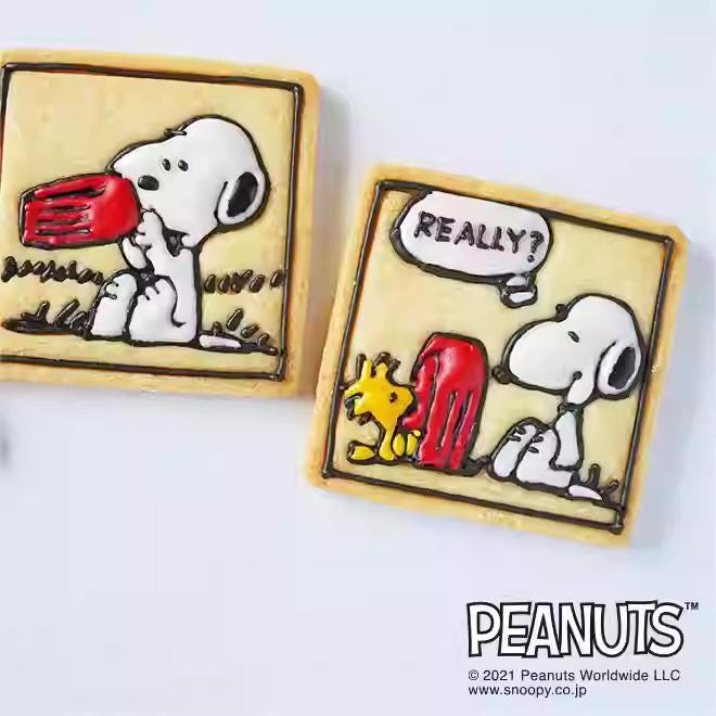 two cookies decorated with the characters from the Peanuts comic strip.