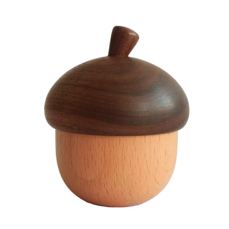 A wooden acorn-shaped object with a brown top and a light orange body.