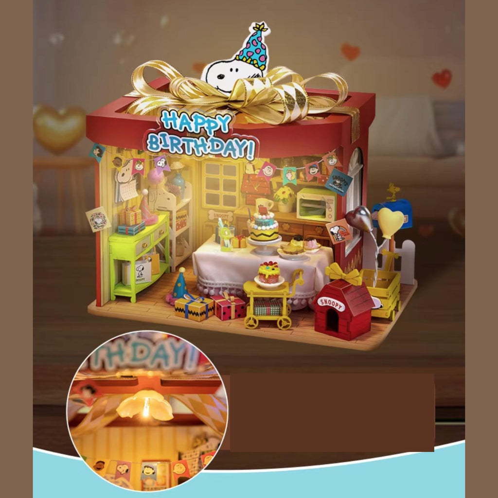 A miniature toy shop decorated for a birthday celebration, featuring a "Happy Birthday!" sign, a Snoopy-themed party hat, and various toys and decorations.