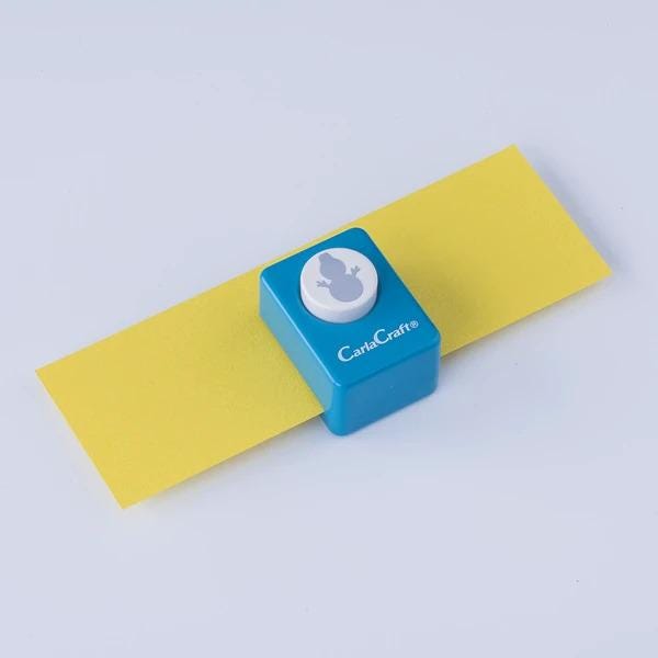A blue and yellow paper punch is shown on a white background.