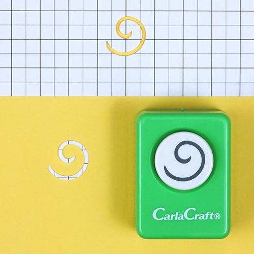 a green circular object with a spiral design on it, placed on a yellow background.