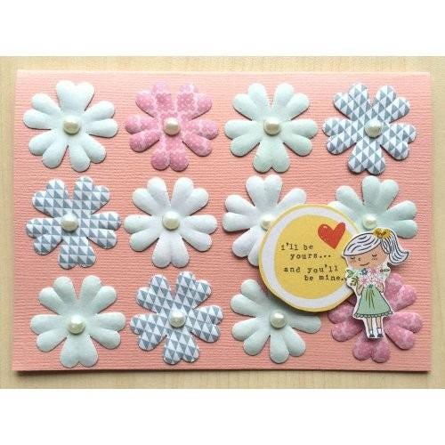 A handmade card featuring a variety of colorful paper flowers, a small illustration of a girl, and a heart-shaped decoration with the text "I'm you... and you'll be mine".