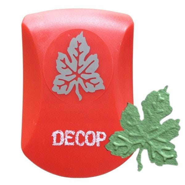 a red object with a white leaf design on it, and there is a green leaf-shaped object next to it.