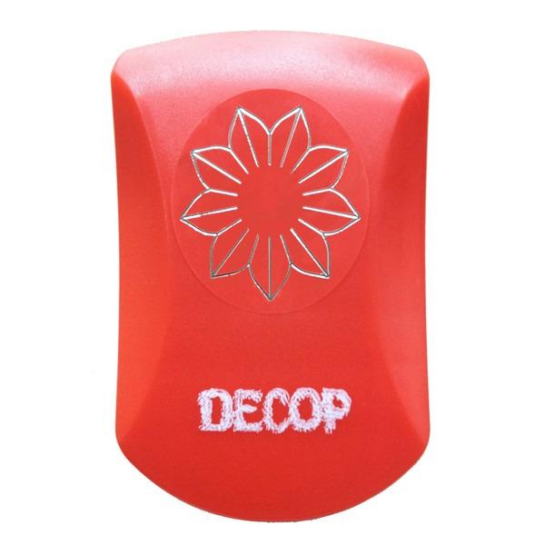 A red object with a silver flower design on it, and the word "DECOP" written on it.