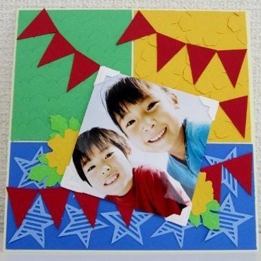 A collage of colorful images, including two smiling children, a green background, and red and yellow triangular shapes, creating a vibrant and playful composition.