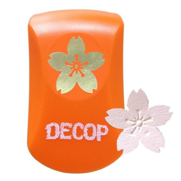 An orange object with a gold flower design and the word "DECOP" written on it.