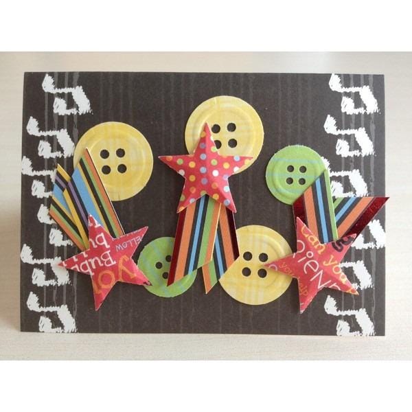 A creative collage of various colorful paper shapes, including stars, buttons, and other decorative elements, arranged on a black background with musical notes.