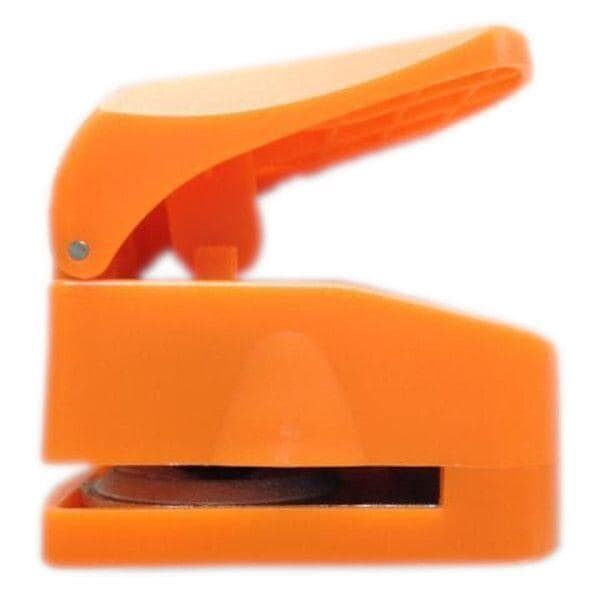 An orange plastic stapler with an open top, ready to staple papers together.