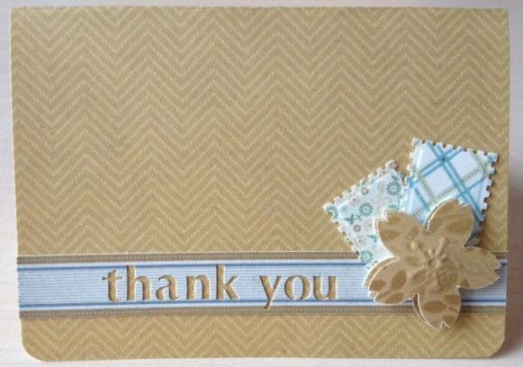 A brown card with a "Thank you" message and decorative elements such as a flower and chevron pattern.