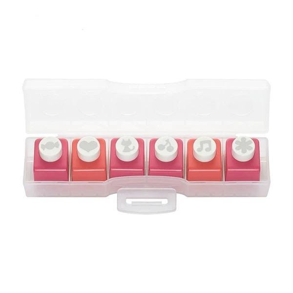 A plastic container with six colorful push pins arranged in two rows of three.