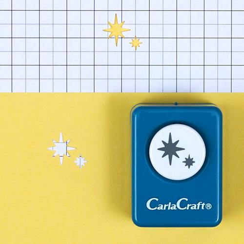 A blue hole puncher with star-shaped cutouts is placed on a yellow background with a grid pattern.