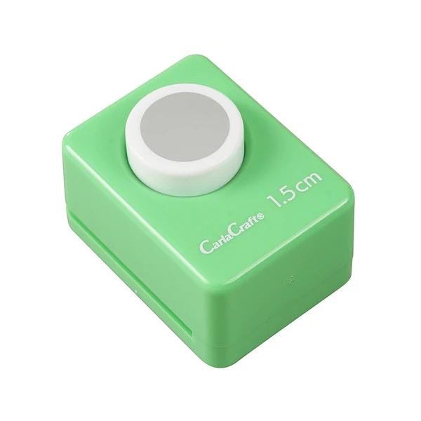 A green push button device with a white circular button on top.