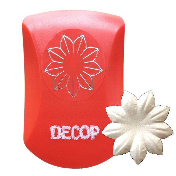 a red object with a silver flower design on it, and there is a white flower-shaped object next to it.