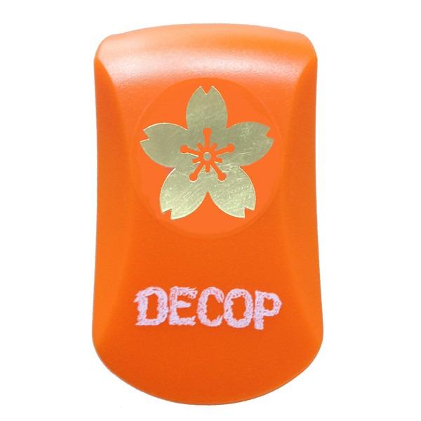 An orange object with a gold flower design and the word "DECOP" written on it.