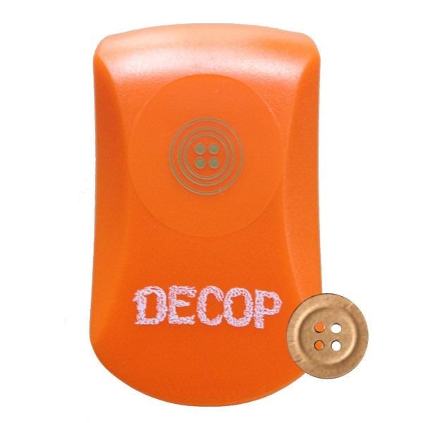 An orange object with the word "DECOP" written on it, along with a small gold button next to it.