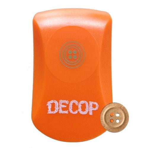 An orange object with the word "DECOP" written on it, along with a small gold button next to it.