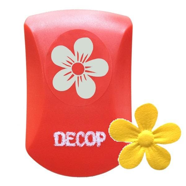 a red object with a white flower design on it, and there is a yellow flower next to it.