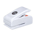 A white plastic hole puncher with a black circular logo on it.