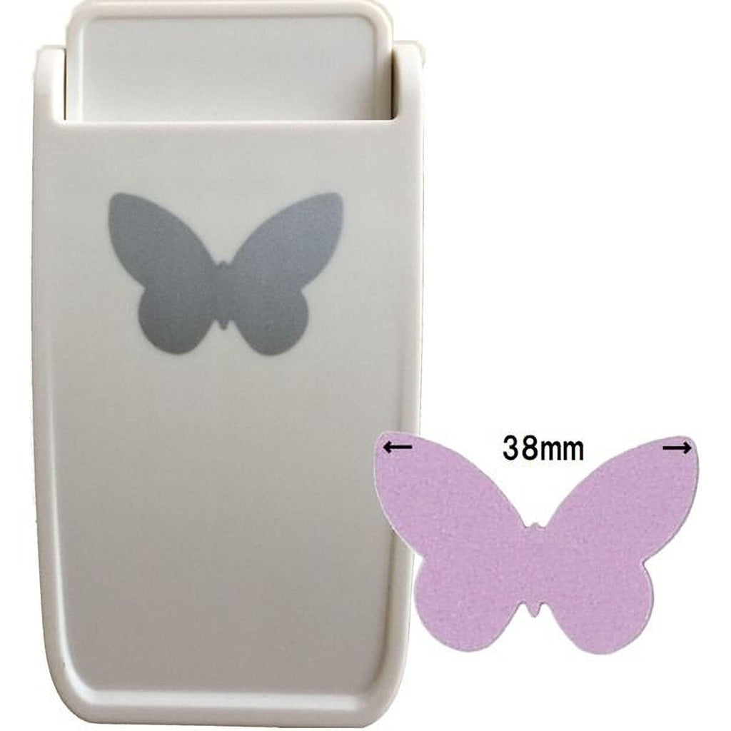 a white plastic object with a silver butterfly design on it, along with a smaller purple butterfly-shaped object next to it.