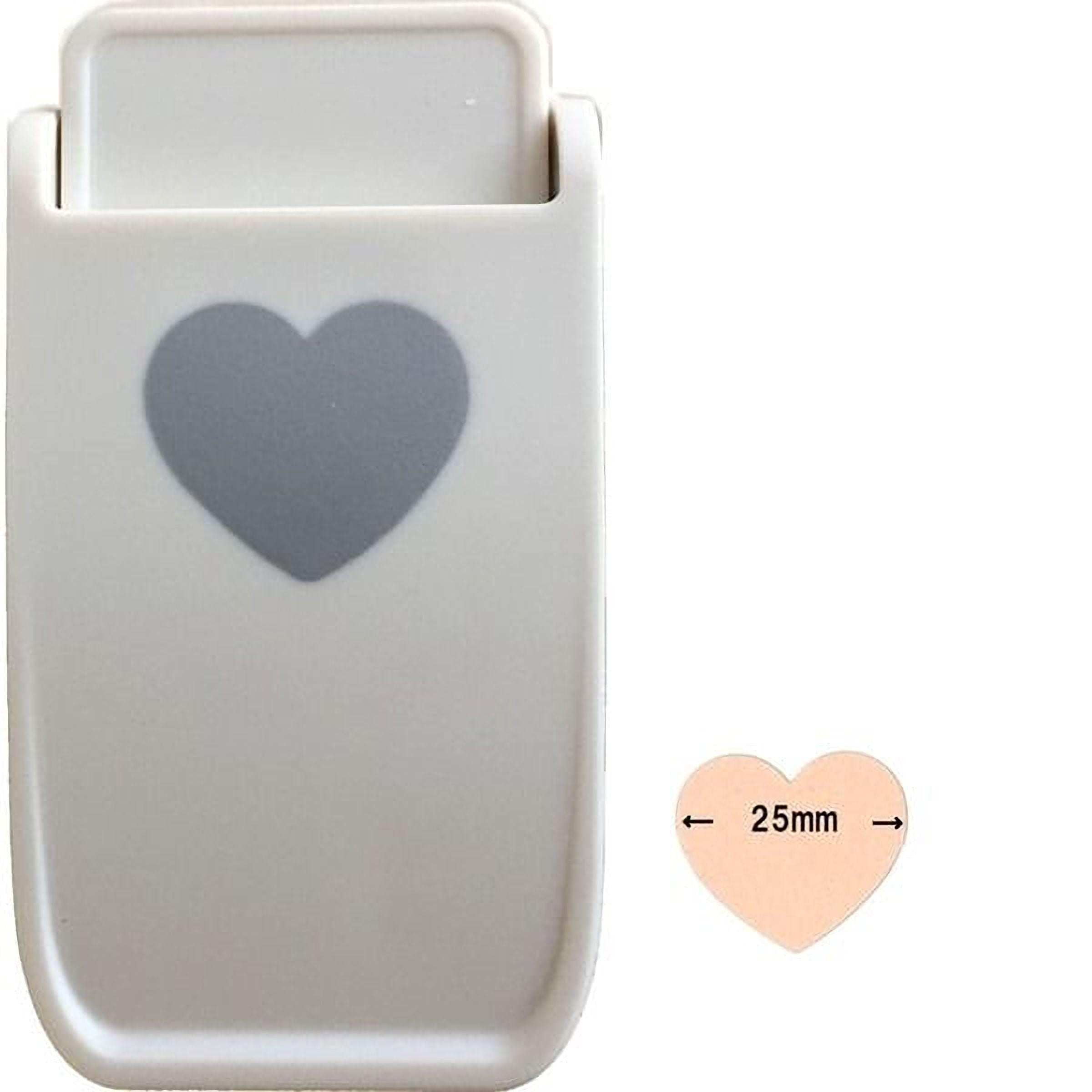 A white plastic object with a heart-shaped cutout on it, along with a smaller heart-shaped cutout indicating its size.