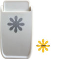 a white plastic object with a gray flower-like design on it, along with a smaller yellow flower-like design indicating the object's size.