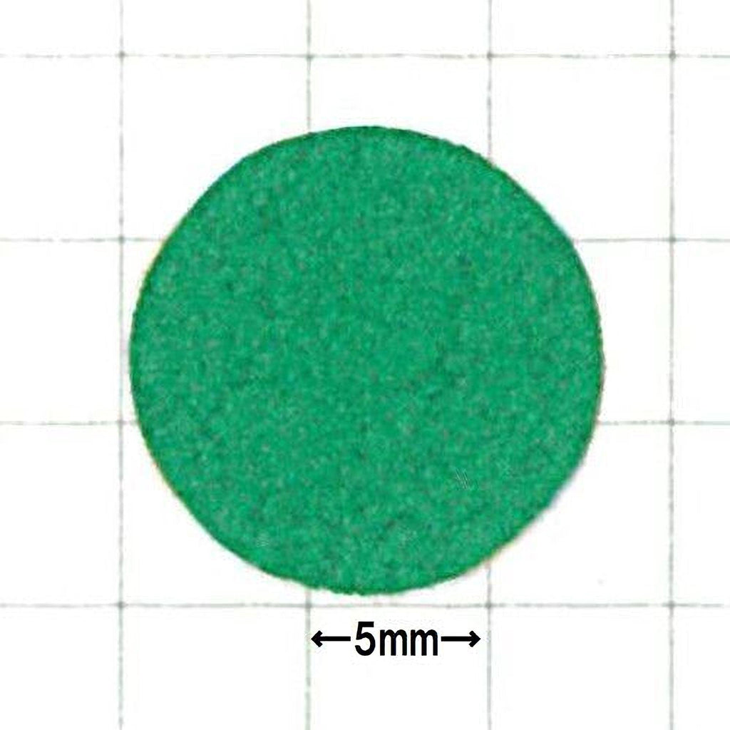 a green circular object, possibly a piece of paper or a small toy, with a size measurement of 5 millimeters indicated below it.