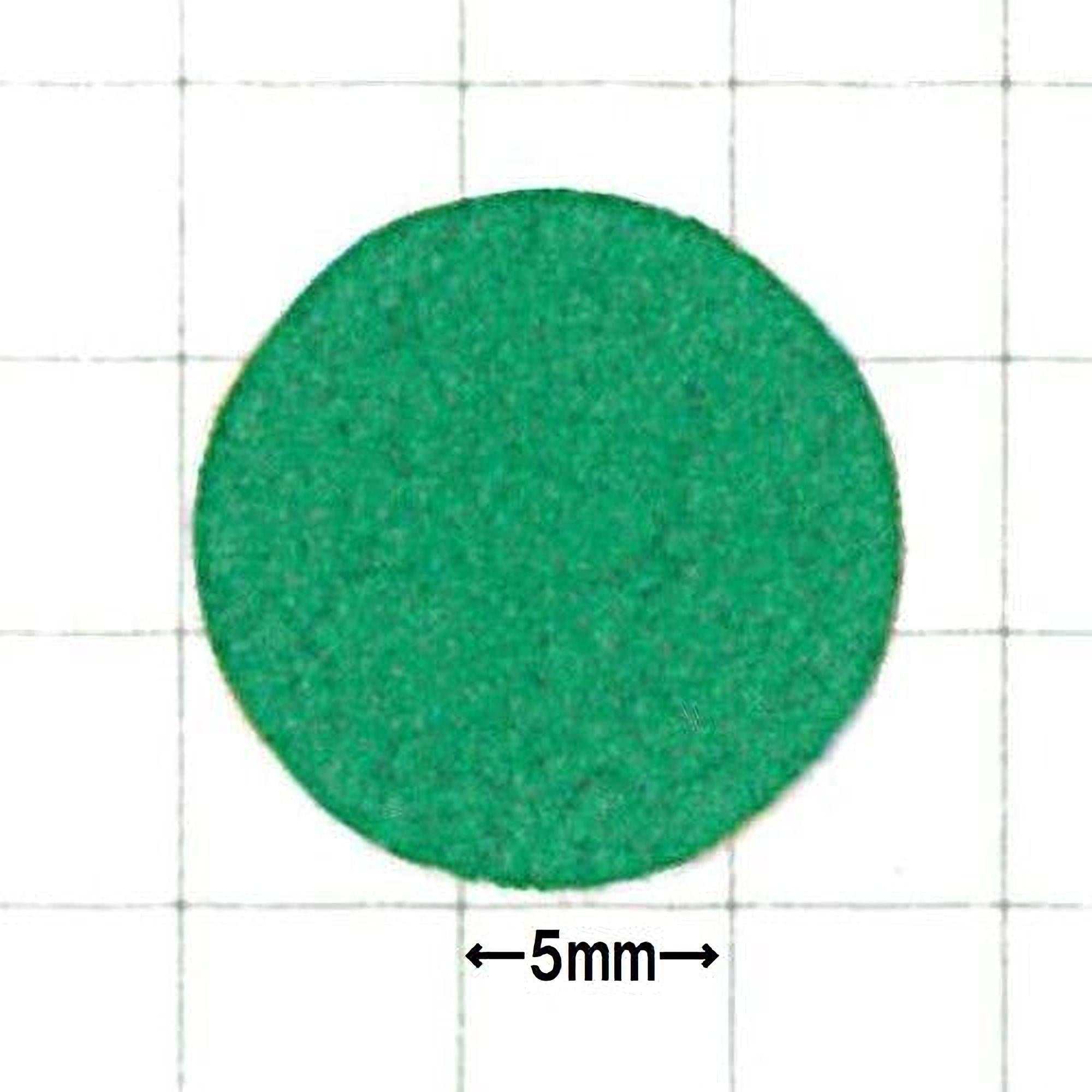 a green circular object, possibly a piece of paper or a small toy, with a size measurement of 5 millimeters indicated below it.