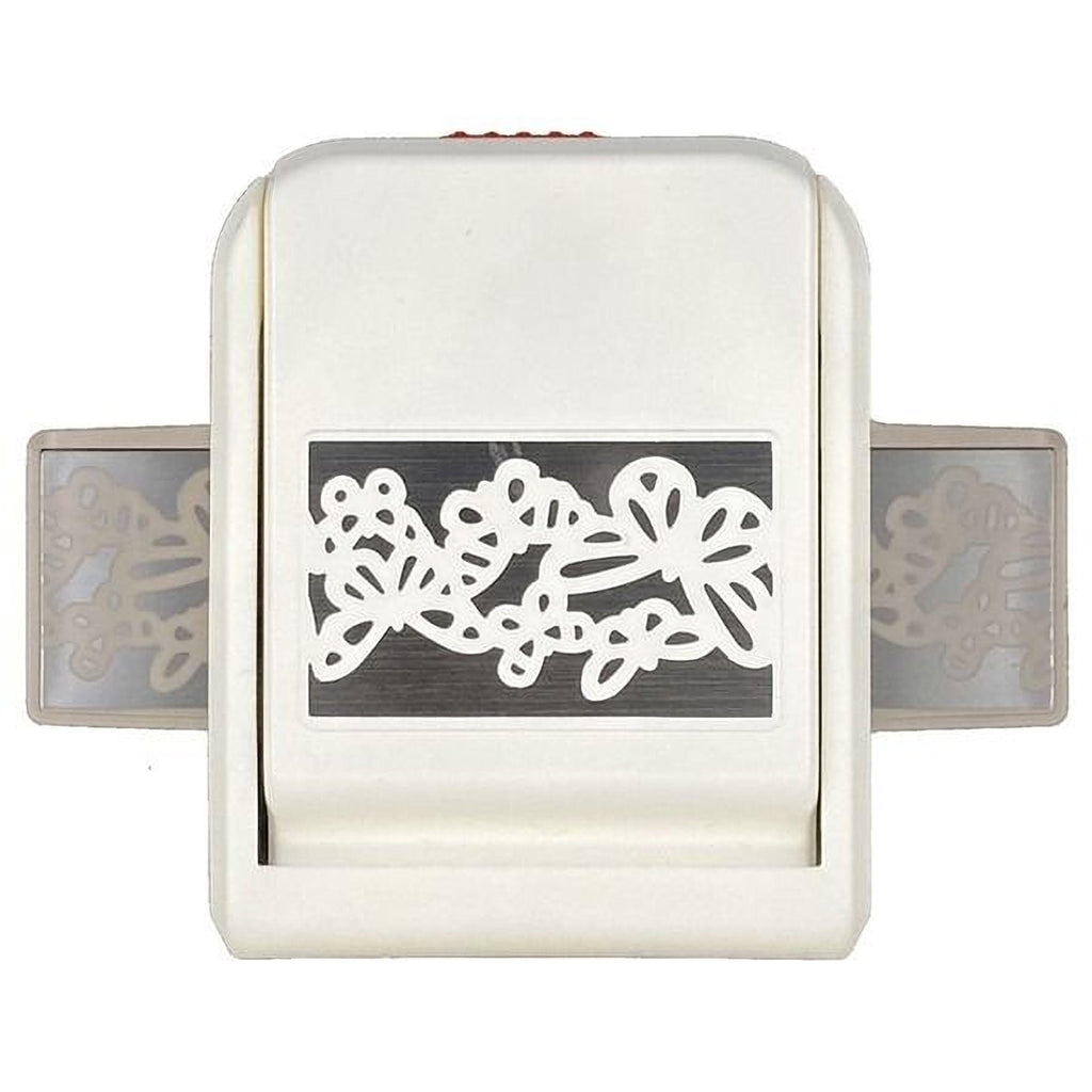 A white plastic tool with a decorative design featuring butterflies on it.