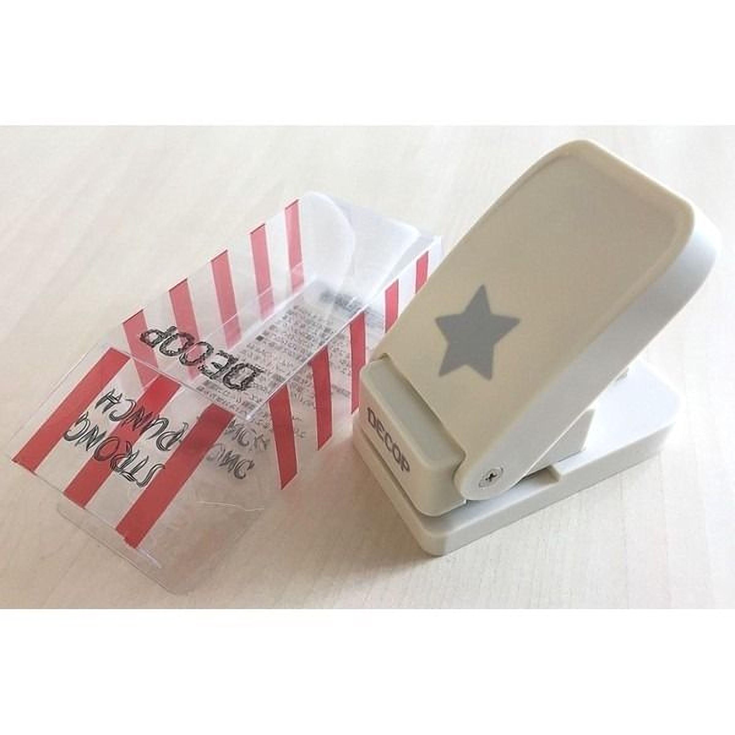 A white plastic punch with a star design on it, placed on a white surface.